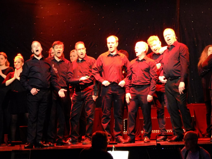 a group of men singing on stage in 'A Walk Through the West End'