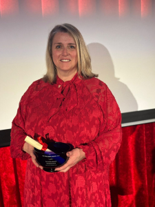 photo of Michelle Hole holding her Rose Bowl award