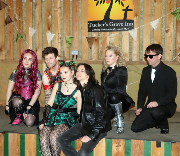 the cast of "We Will Rock You" in costume for a promotional photo-shoot.