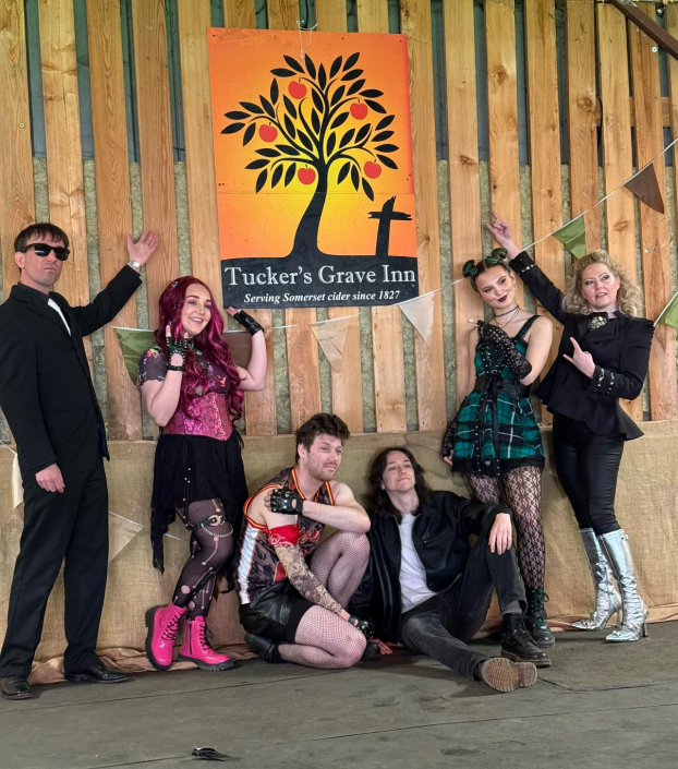 the cast of "We Will Rock You" in costume for a promotional photo-shoot.