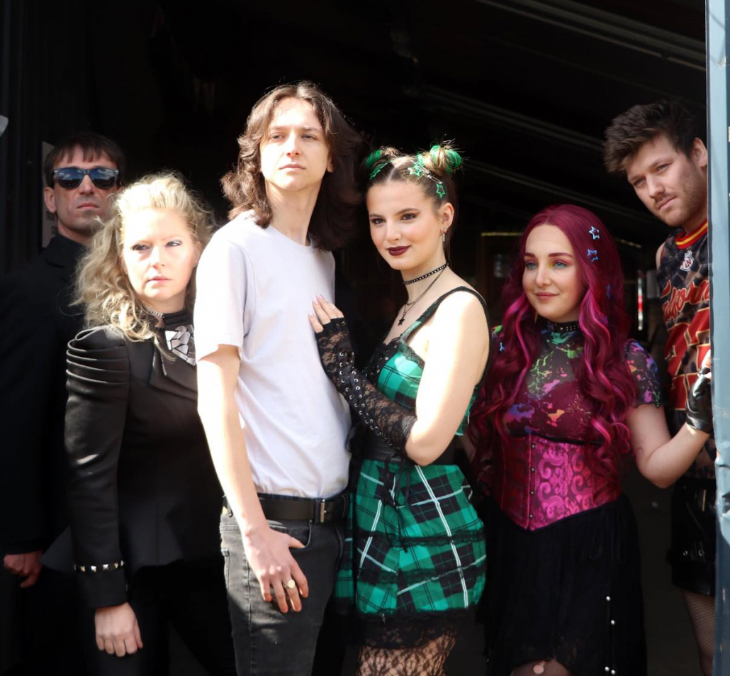 the cast of "We Will Rock You" in costume for a promotional photo-shoot.