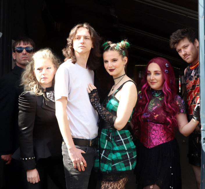 the cast of "We Will Rock You" in costume for a promotional photo-shoot.