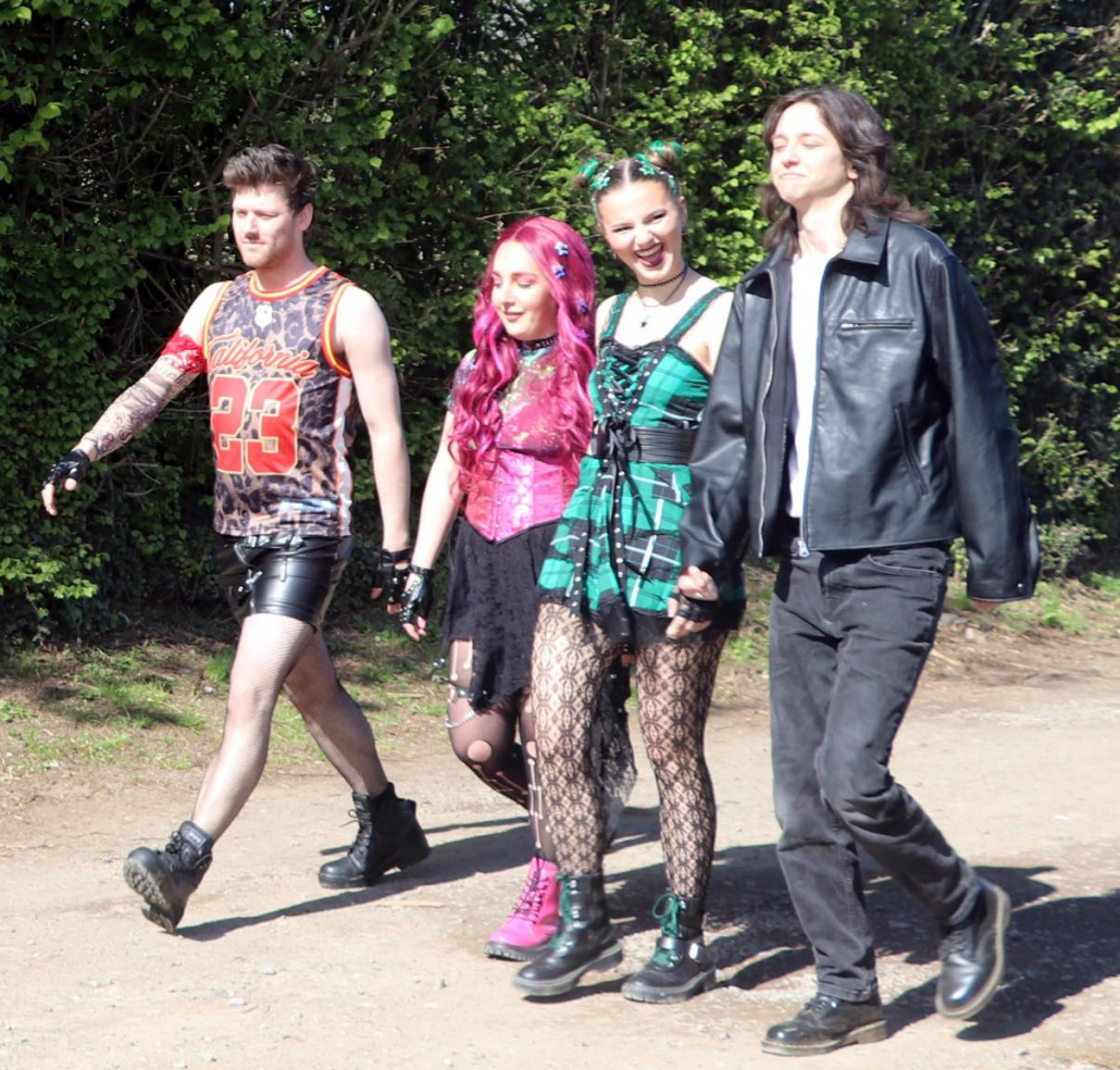 the cast of "We Will Rock You" in costume for a promotional photo-shoot.