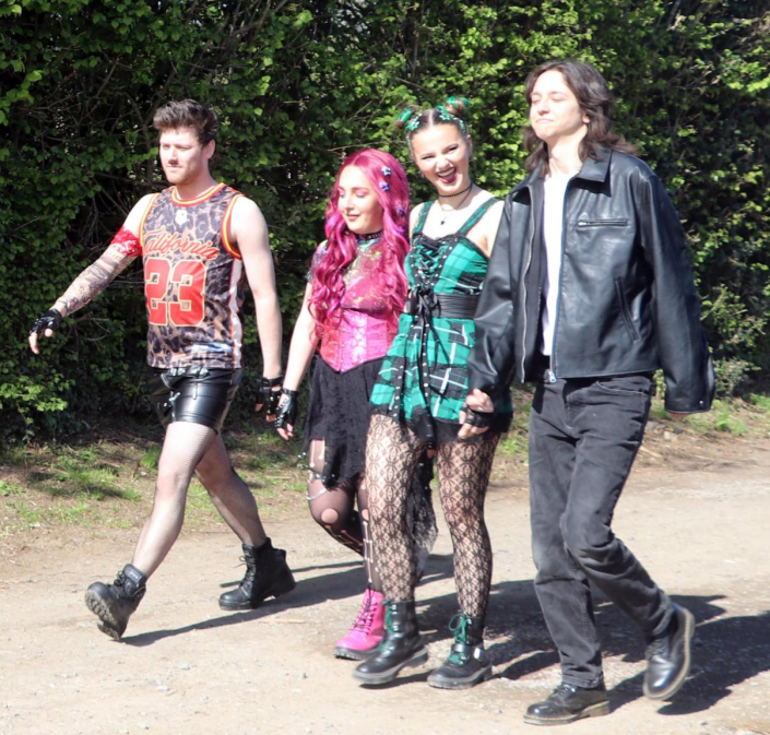 the cast of "We Will Rock You" in costume for a promotional photo-shoot.