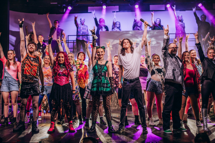 the full cast of "We Will Rock You" photographed live on stage